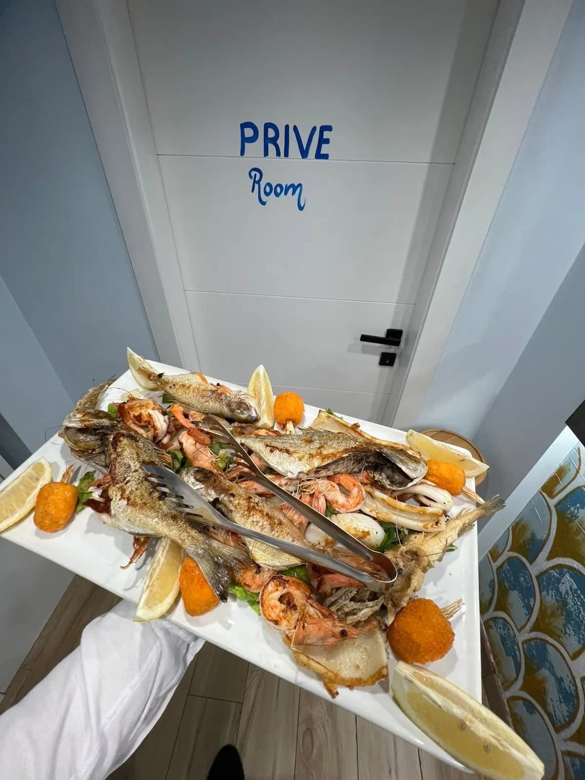 Pjatë e madhe me peshk dhe fruta deti të përgatitura në zgarë
